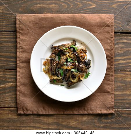 Fried Beef Liver With Onion On Plate Over Wooden Background. Pieces Cooked Liver (offal) From Beef. 