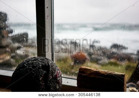 Look Through The Window Of A Old Cabin On To The Wild Ocean On Lofoten Islands.