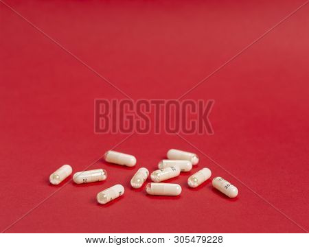 Variety Of White Capsules On A Colored Background