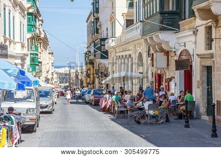 Valetta, Malta - September 13th 2015: Tourists Sat Outside On The Main Street. The City Is A Popular
