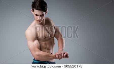 Young Male Athlete Bodybuilder Posing. Handsome Athletic Male Power Guy. Fitness Muscular Person. Yo