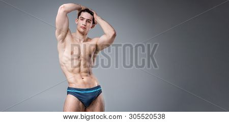 Young Male Athlete Bodybuilder Posing. Handsome Athletic Male Power Guy. Fitness Muscular Person. Yo