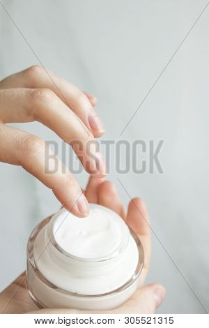 Young Woman Cares About Her Hands, Applying Cream On Them.close Up Shot Of Hands And Whire Cream.top
