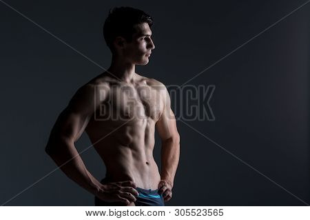 Young Male Athlete Bodybuilder Posing. Handsome Athletic Male Power Guy. Fitness Muscular Person. Yo