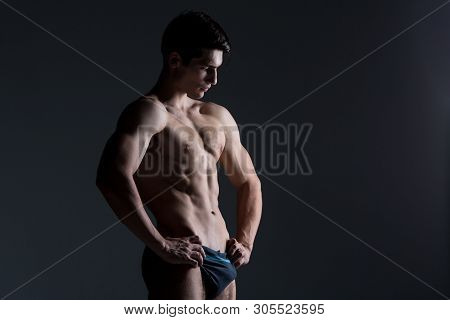Young Male Athlete Bodybuilder Posing. Handsome Athletic Male Power Guy. Fitness Muscular Person. Yo