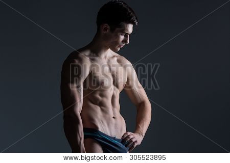 Young Male Athlete Bodybuilder Posing. Handsome Athletic Male Power Guy. Fitness Muscular Person. Yo