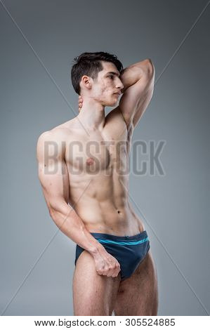 Studio Portrait Young Caucasian Man On Gray Background Posing. Theme Of Puberty, Problem Skin, Teen 