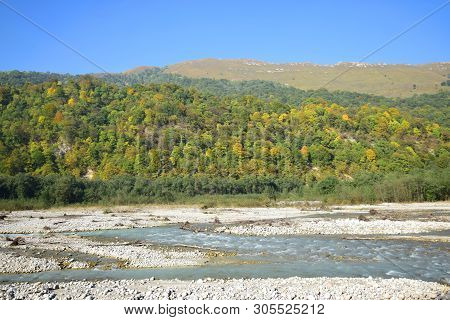 Panorama Of The Fast Mountain River With Stones And Mountains With Green Trees In The Cherek Gorge I