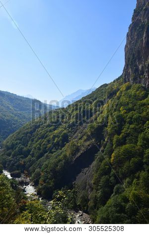 View Of The Evening Mountain River In A Gorge With Stones And Mountains With A Forest In Cherek Gorg