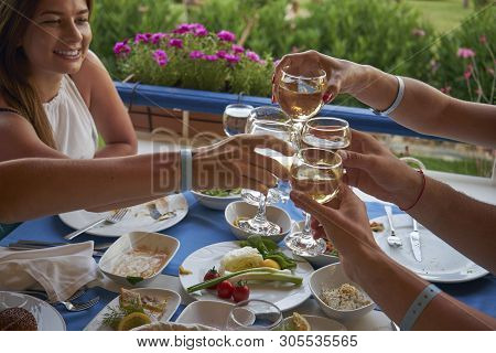Friends Have Dinner In A Elicious Restaurant