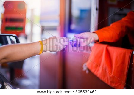 Blurry Hands Of Driver Pay For The Expressway.