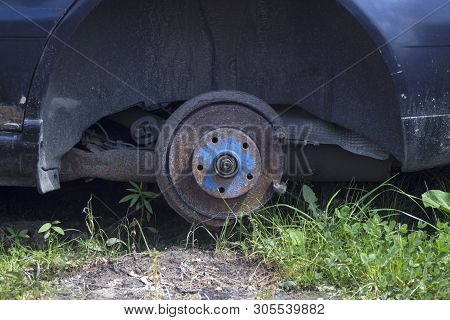 Old Rusty Car Without Rear Wheel Oustside