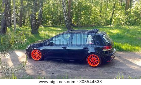 Russia, Moscow - June 01, 2019: Black Volkswagen Golf Mk6 Tuned With Ragtop And Orange Wheels. Stanc