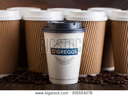 London, Uk - June 05, 2019: Greggs Coffee Paper Cup For Take Away With Coffee Beans On Wooden Backgr