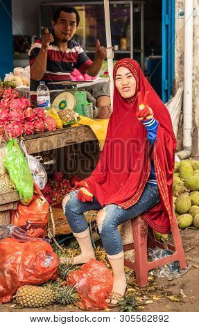 Makassar, Sulawesi, Indonesia - February 28, 2019: Terong Street Market. Two Vendors Make Positive H