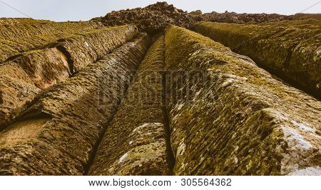 Looking Up At Moss Growing On Natural Rock Pillar Formation.