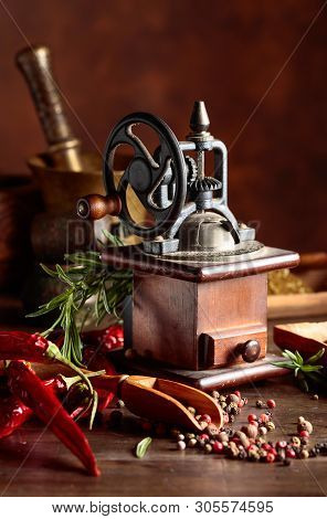 Vintage Pepper Mill With Various Peppers And Spices. Old Pepper Mill With Kitchen Utensils, Spices A