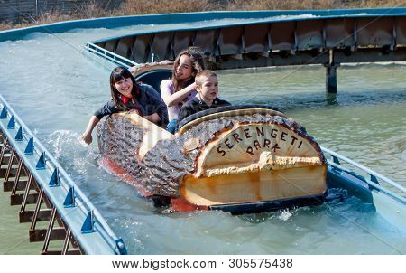 Hodenhagen, Germany, March 30, 2019: Children Sailing In A Boat In The Form Of A Log On A Waterway I
