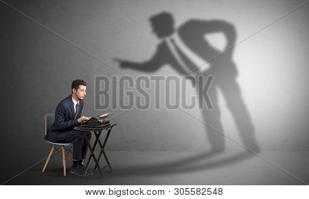 Little man working and a big shadow arguing with him
