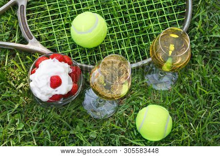 Strawberries With Whipped Cream, Glasses With Champagne And Tennis Equipment On Wimbledon Tournament