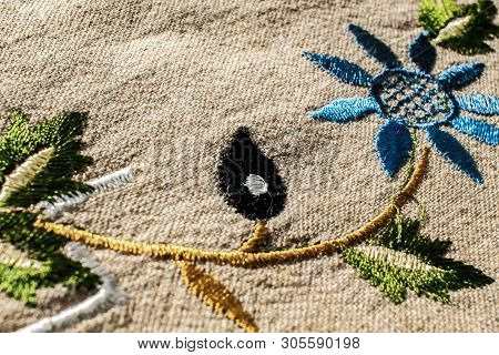 Linen Fabric Texture . Embroidered Flowers . Beautiful Cloth From Natural Fabric