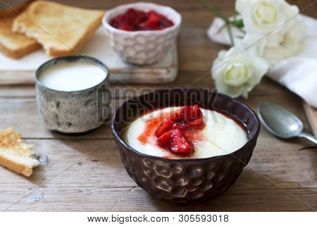 Homemade Breakfast Of Semolina Porridge, Strawberry Sauce, Coffee With Milk And Toast On A Wooden Ba