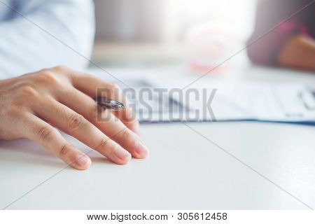 Dentist Talking To Male Patient And Presenting Results On Dental X-ray Film About The Problem Of The