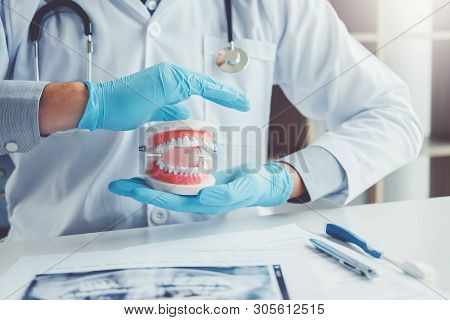 Dentist With Denture Learning How To Teeth At Dentists Office