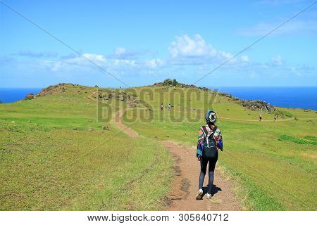 Female Tourist Visiting Orongo Village, The Historic Ceremonial Center On Easter Island, Chile, Sout