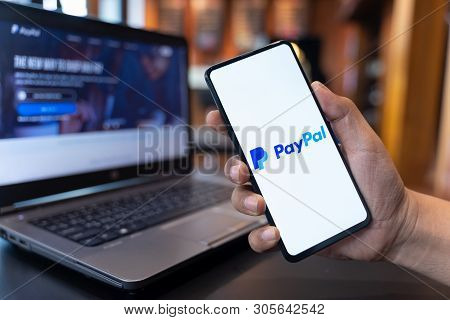 Chiang Mai, Thailand - May.01,2019: Man Holding Xiaomi Mi Mix 3 With Paypal Apps On The Screen. Payp