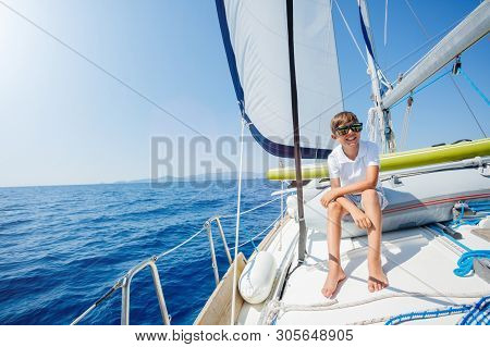 Little Boy On Board Of Sailing Yacht On Summer Cruise. Travel Adventure, Yachting With Child On Fami
