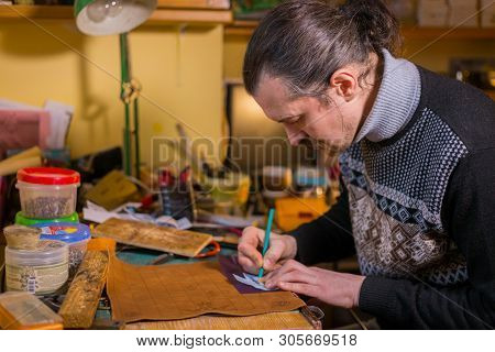 Professional Male Skinner, Tanner Making Decorative Details On Leather Playing Field For Strategy Bo