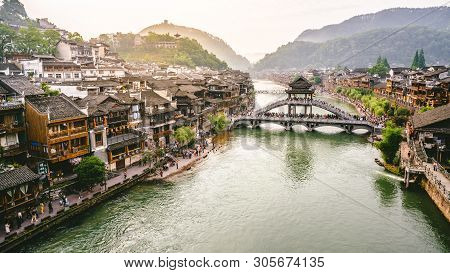 2 June 2019, Fenghuang China : Tuo Jiang River Panorama With Antique Bridge And Dramatic Light In Fe