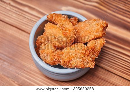 Chicken Strips In A Clay Pot On A Wooden Table