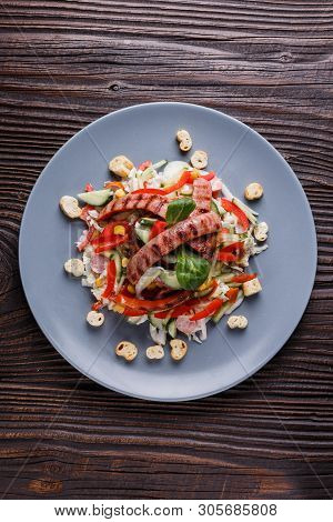 Salad With Grilled Sausage Paprica Cucumber And Croutons