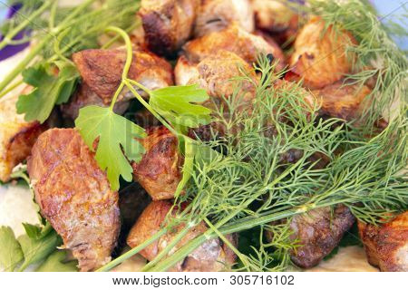 Chopped  Bbq Pieces Of  Mutton, Beef Or Chicken Meat On The Plate With Greenery Of Parsley And Dill