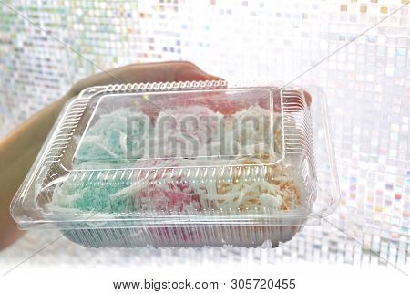 Thai Traditional Dessert, Hand Holding Thai Colorful Coconut Muchkins Or Sticky Rice Balls Stuffed W