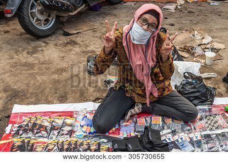Makassar, Sulawesi, Indonesia - February 28, 2019: Terong Street Market. Ambulant Woman Sits On Dirt