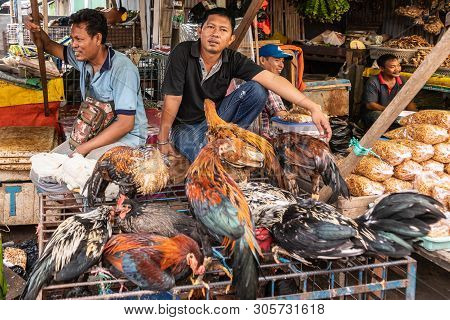 Makassar, Sulawesi, Indonesia - February 28, 2019: Terong Street Market. Two Men Sell Living Chicken