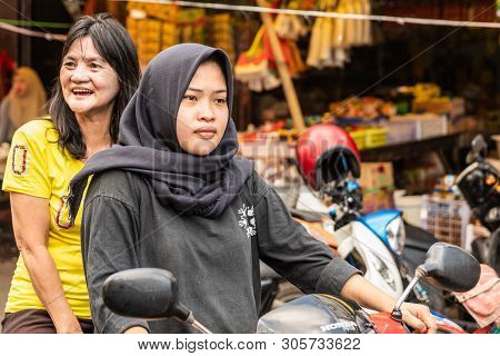 Makassar, Sulawesi, Indonesia - February 28, 2019: Terong Street Market. Closeup Of Two Women On Mot