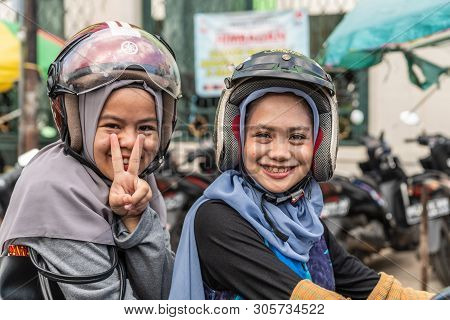 Makassar, Sulawesi, Indonesia - February 28, 2019: Terong Street Market. Closeup Portrait Of Two Smi