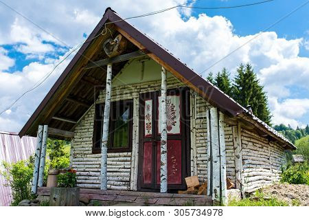 Ciba, Romania- 10 June 2019: Traditional House Covered With Birch Wood, Blue Sky With White Clouds O