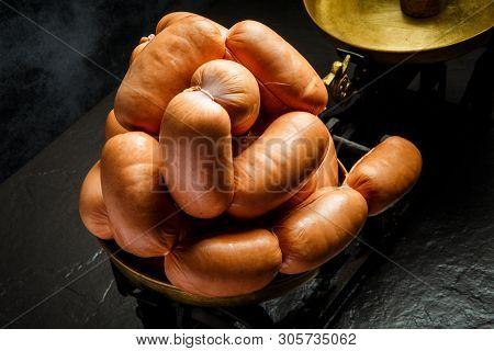 Closeup Heap Of Short Thick Wieners Rolled In Spiral On Scales