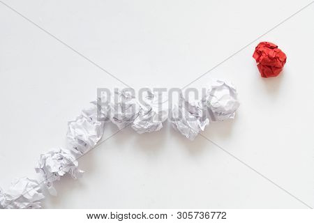 Leadership Concept. Flat Lay Of Crumpled Same Color Paper Ball Line Following Individual Red One. Wh