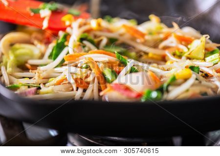 Process Of Cooking Of Sweet And Crunchy Stir Fry With Beansprouts In The Wok, Macro Image