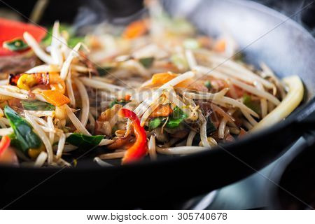 Process Of Cooking Of Sweet And Crunchy Stir Fry With Beansprouts In The Wok, Macro Image
