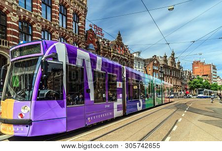 Amsterdam, The Netherlands - May 23, 2019: Modern Tram In Front Of Magna Plaza, The Shopping Center 