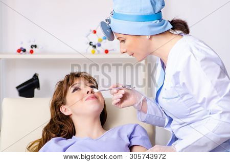 Young woman visiting female doctor otolaryngologist