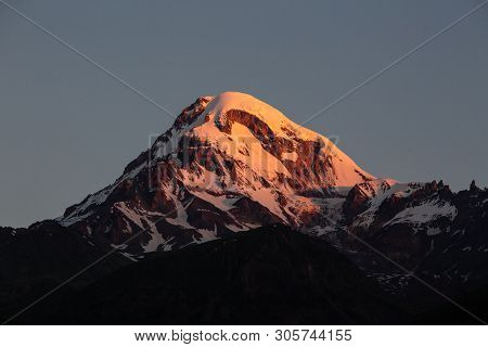 Landscape View Of Mountain Kazbeg On Sunrise, Caucasus Mountains, Country Of Georgia