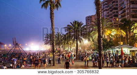 Malaga, Spain - June 23, 2018. Night Scene With Many People At The Malagueta Beach In The Celebratio